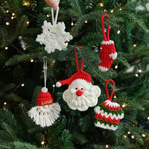 Handmade crochet Christmas ornaments including Santa, snowflake, and sock on a festive tree