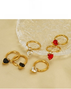 Detailed macro view of 18K gold-plated heart earrings with red, black, and clear zircons