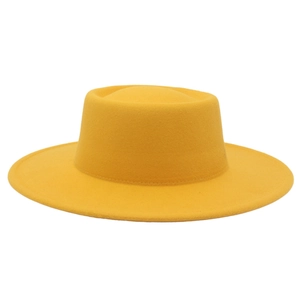 Close-up detail of a yellow wool felt boater hat featuring a flat top and wide brim design