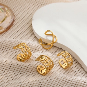 Set of four gold-plated ear cuffs with cross, braided chain, and leaf designs for non-pierced ears