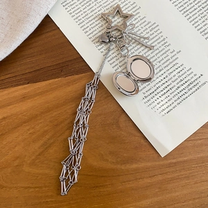 Close-up of heart charm with metal tassel chain and star-shaped lobster clasp