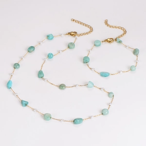 Detailed set of gold chain necklace and bracelet with light green stones and pearls