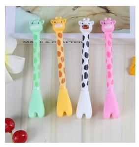 Detail of four colorful giraffe gel pens in green yellow white and pink colors
