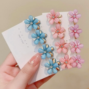 Floral mini claw hair clips in pastel colors with rhinestones on a display card