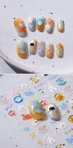 Detail shot of 3D embossed nail stickers featuring cute cartoon crab and seal patterns