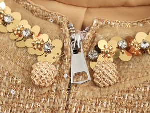 Detail of tweed neckline with gold sequins, crystal flowers and metallic zipper closure