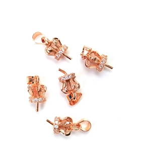 Macro shot of rose gold crown-shaped pendant bails with micro-pave white zircon details