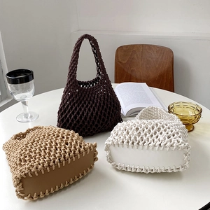 Set of three woven cotton rope tote bags in brown, white and beige colors with leather base