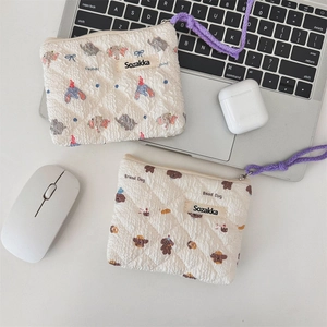Macro view of floral quilted cotton coin purses with elephant and bread dog motifs
