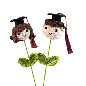 Handmade crochet graduation bouquet featuring boy and girl dolls with black mortarboards