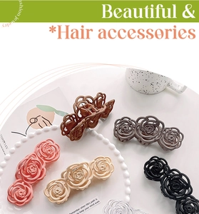 Detail view of 6 colorful matte hollow rose hair claws on a stylish decorative tray