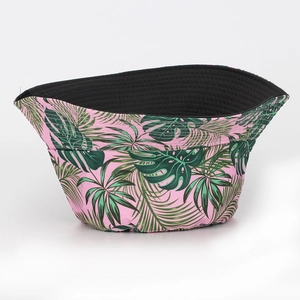 Detail view of tropical leaf print bucket hat with pink base and black lining