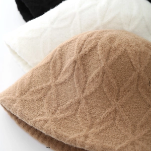 Chic plush bucket hat in khaki, white, and black with thick diamond knit texture