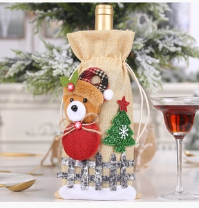 Close-up of burlap wine bottle bag featuring a 3D plush bear and sequin Christmas tree