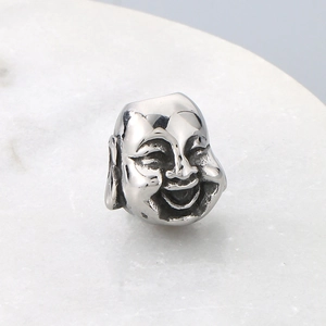 Macro shot of silver stainless steel Buddha face spacer bead for jewelry making