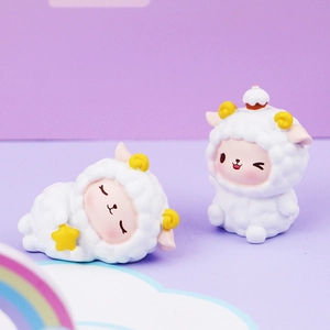 Close-up of cute cartoon sheep figurines with star and cake decorations on a dreamlike backdrop