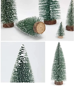 Macro shot of flocked mini Christmas trees with white faux snow and wooden bases
