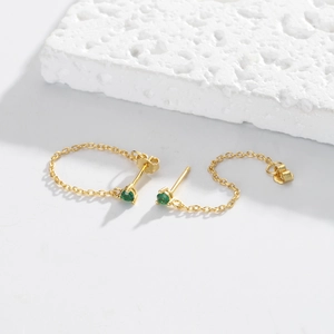 Detailed macro shot of S925 sterling silver chain earrings with green zircon gems