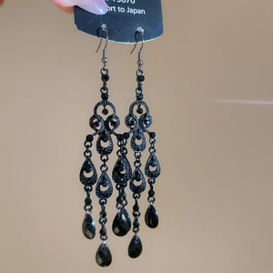 Detail of vintage black hollow teardrop crystal drop earrings in baroque style