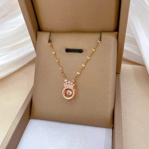 Elegant rose gold crown necklace with a dancing diamond pendant in a gift jewelry box