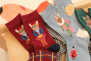 Detailed view of forest animal jacquard patterns on cotton socks with cat and rabbit art