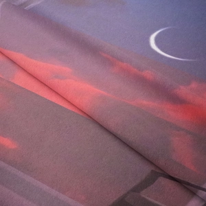 Detailed view of bohemian tapestry showing soft fabric texture and moon cloud print