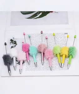 Detail of colorful plush bead pens in 8 vibrant colors on a magazine background