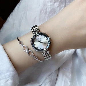 Elegant silver steel watch with faceted bezel and matching infinity diamond bracelet
