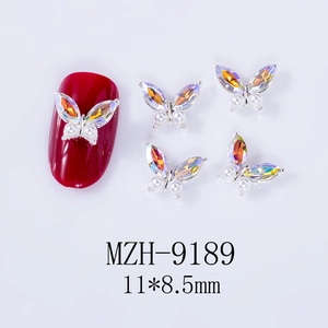 Detail of 3D alloy butterfly nail charm with AB crystals and pearls on red base
