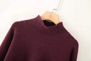 Close-up of soft rib-knit mulberry purple sweater with a stylish mock neck design