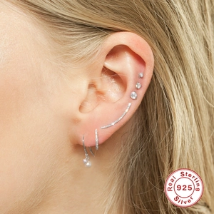 Detailed view of sterling silver earrings featuring pearls and sparkling cubic zirconia