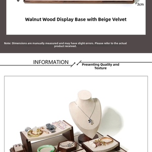 Detailed view of walnut wood jewelry stand set with beige velvet lining and necklace busts