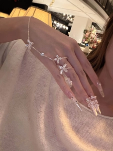 Close-up of elegant silver zircon flower slave bracelet on hand