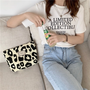 Detailed macro view of black and white leopard print canvas tote with a white woven label