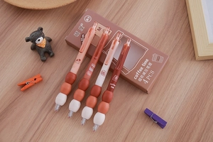 Detail of coffee-themed gel pens with soft ergonomic grips in original box packaging
