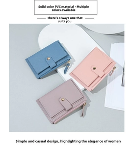 Close-up of litchi texture PVC wallets with golden snap buttons and zippers