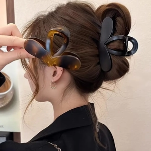 Elegant heart-shaped hair claw clips in tortoiseshell and black for women's updos
