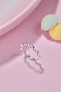 Detailed macro view of S925 silver wavy ring with multi-colored cubic zirconia stones