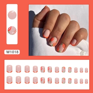 Short orange press-on nails with cute citrus patterns and French tips for summer wear