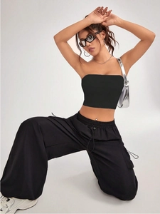 Sleeveless black ribbed knit crop top and wide-leg cargo pants set for athletic street style