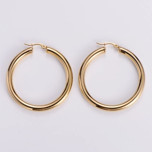 Detailed close-up of polished 18k gold plated stainless steel hollow hoop earrings