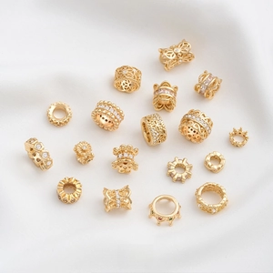 Macro detail of 14K gold plated hollow spacer beads with cubic zirconia for DIY jewelry