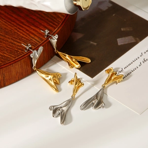 Detail of irregular bicolored stainless steel earrings in gold and silver finish
