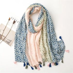 Detailed shot of floral print scarf with multi-color tassels and lightweight texture
