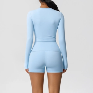 Women's light blue athletic yoga set featuring long sleeve top and high waist shorts