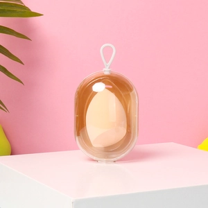 Space capsule makeup sponge set with a beige sponge in a transparent plastic case