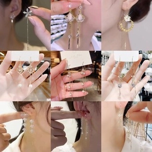 Collage of nine elegant butterfly tassel earrings with pearls and crystals in gold finish