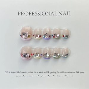 Detailed view of 3D sweet style press-on nails with heart gems and colorful rhinestones
