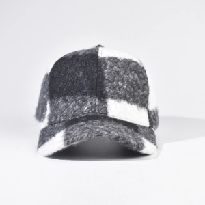 Detailed view of the classic plaid pattern on the thick wool-like baseball cap fabric