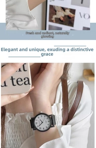 Close-up of minimalist MSTIANQ quartz watch with white dial and black leather strap for women
